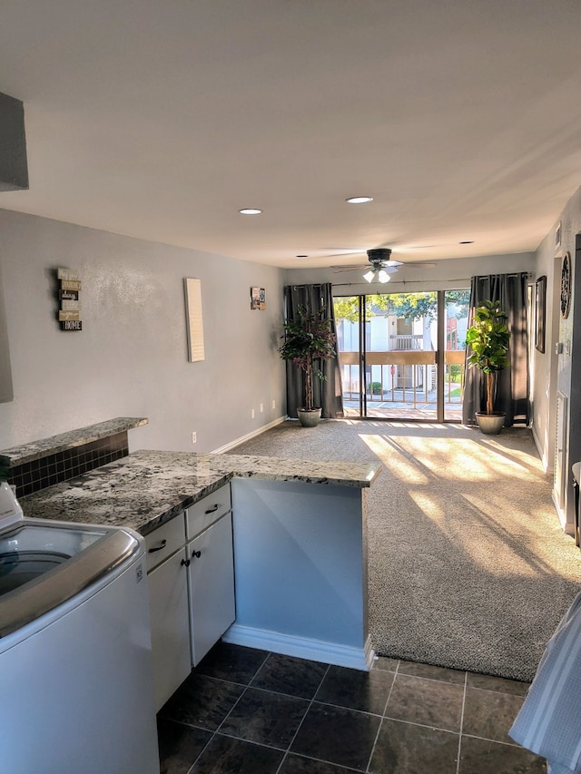 12100 Melville Dr Unit 406D, Montgomery, TX 77356 - kitchen featuring stove, a ceiling fan, baseboards, white cabinets, and light stone countertops