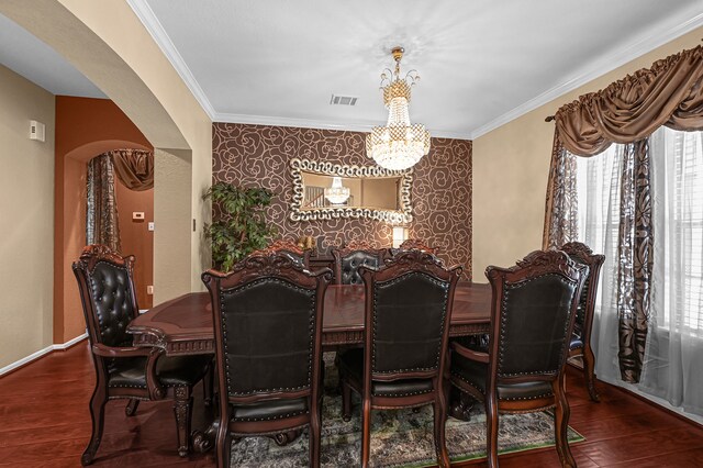 dining space with crown molding, an inviting chandelier, and dark hardwood / wood-style flooring