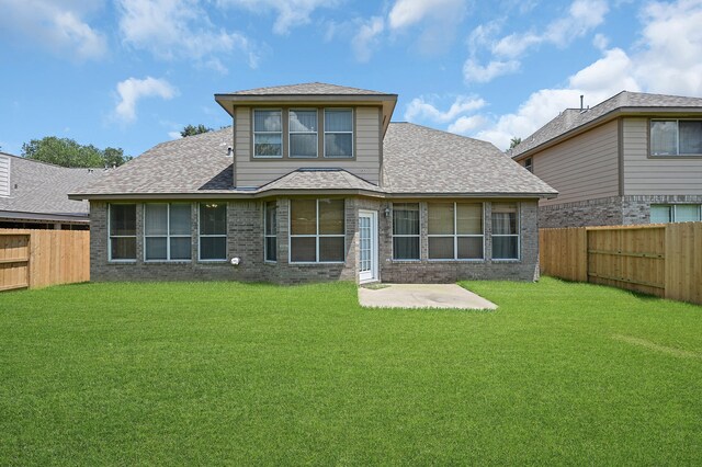 back of house featuring a yard and a patio