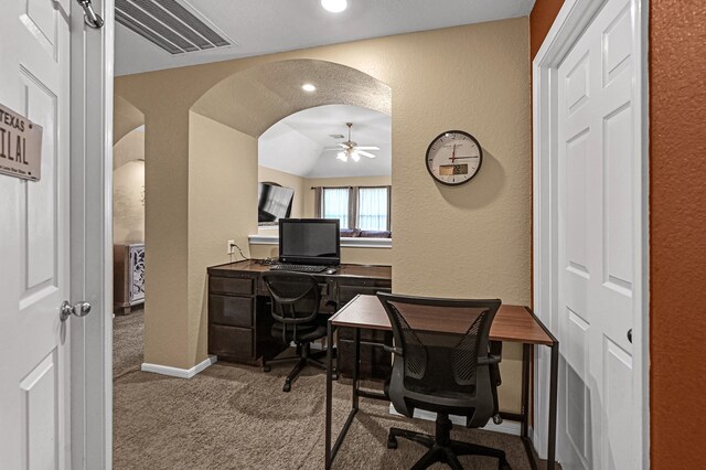 carpeted office with vaulted ceiling and ceiling fan