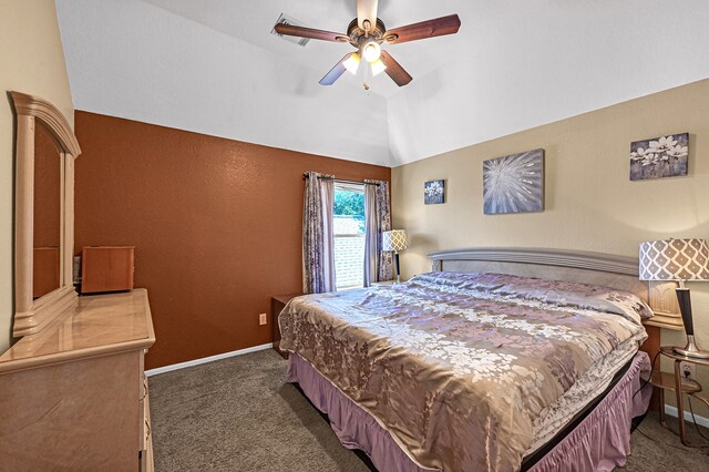 bedroom with dark colored carpet, ceiling fan, and vaulted ceiling