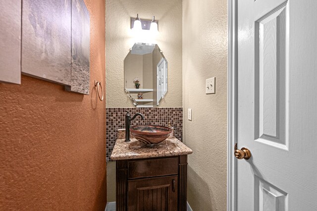 bathroom with vanity and backsplash