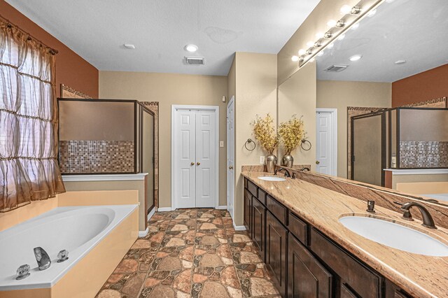 bathroom featuring vanity and shower with separate bathtub