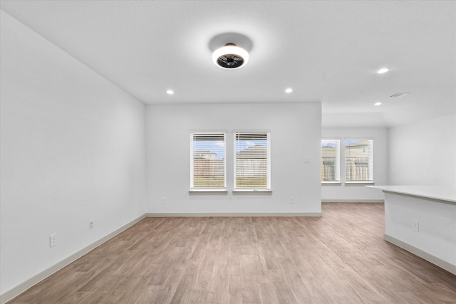 empty room featuring recessed lighting, light wood-style floors, and baseboards