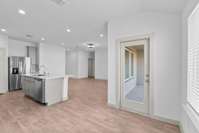 kitchen featuring stainless steel appliances, plenty of natural light, a sink, and gray cabinets