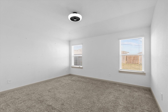 carpeted spare room with baseboards