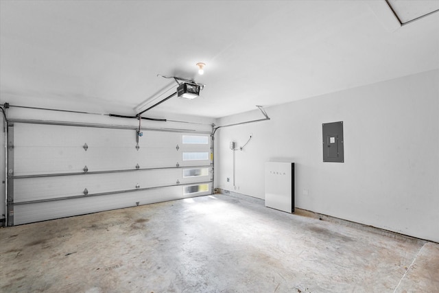 garage with a garage door opener and electric panel