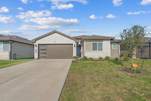view of front of house featuring a garage, brick siding, driveway, and a front lawn