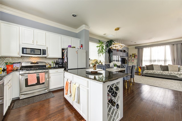 kitchen featuring white appliances, white cabinetry, and dark hardwood / wood-style floors