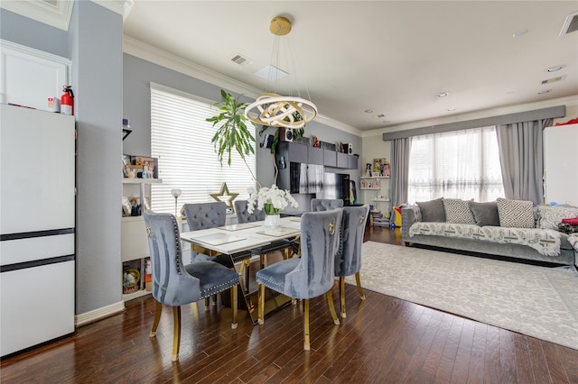 dining space featuring crown molding and dark hardwood / wood-style flooring