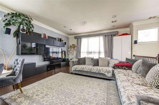 living area with wood finished floors, healthy amount of natural light, crown molding, and recessed lighting