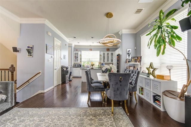 dining space featuring dark wood finished floors, ornamental molding, baseboards, and recessed lighting
