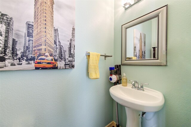 bathroom featuring a view of city and a sink
