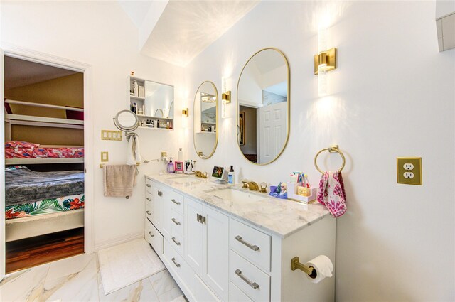 full bath with ensuite bath, marble look tile flooring, and double vanity