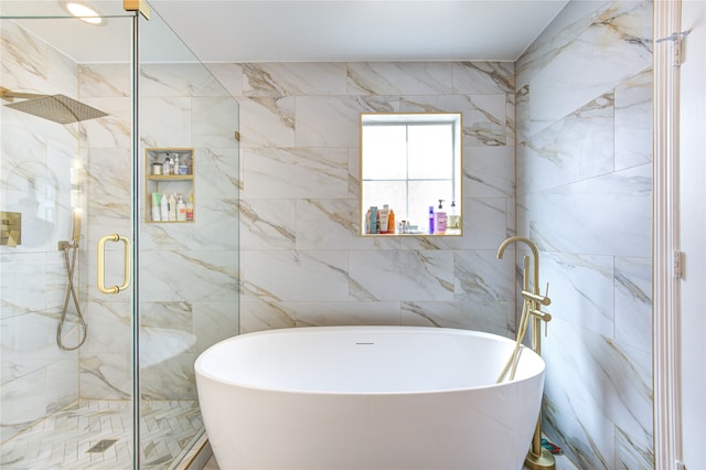 bathroom featuring plus walk in shower and tile walls