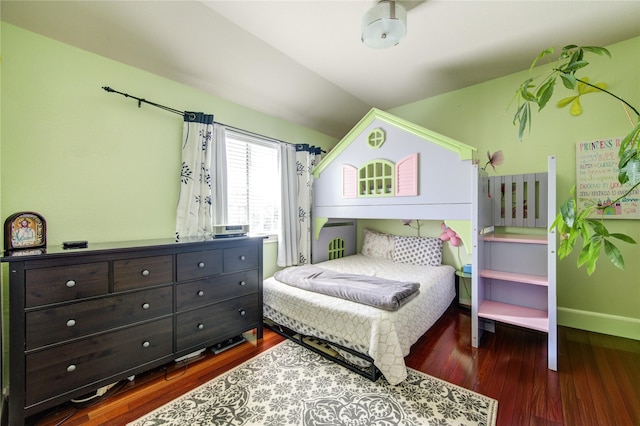 bedroom with wood finished floors, baseboards, and vaulted ceiling