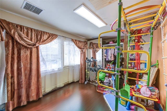 playroom with dark wood-type flooring