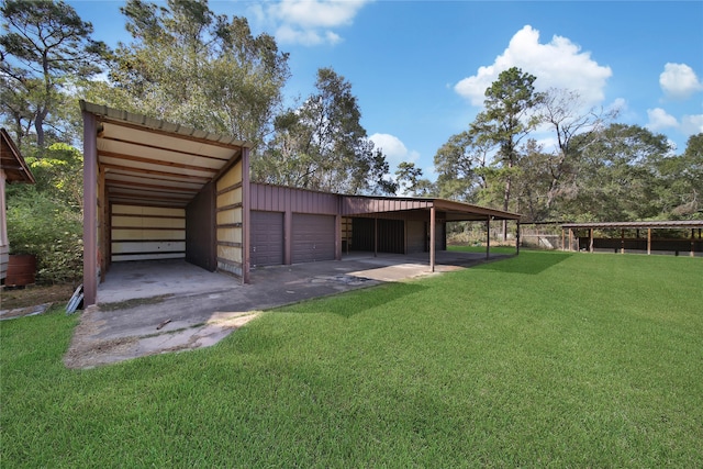 exterior space with a carport and a yard