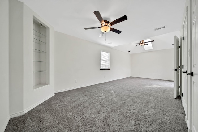 empty room with ceiling fan, built in features, and dark colored carpet