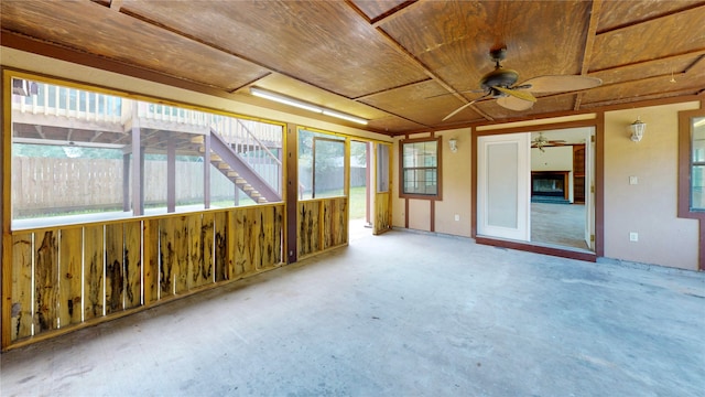 unfurnished sunroom featuring ceiling fan