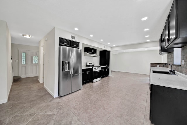 kitchen featuring light tile patterned floors, stainless steel appliances, and sink