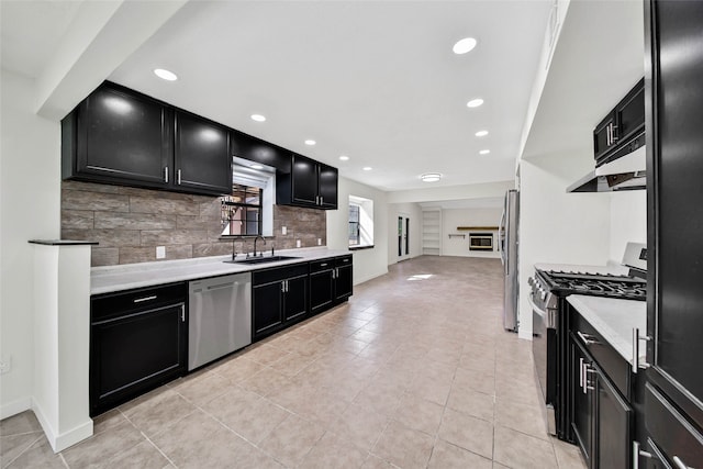 kitchen with decorative backsplash, sink, light tile patterned flooring, and appliances with stainless steel finishes