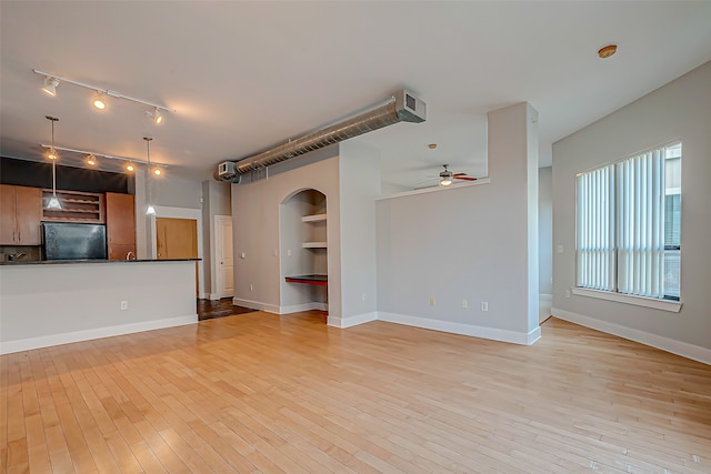 unfurnished living room with light hardwood / wood-style floors and ceiling fan