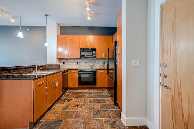 kitchen with track lighting, sink, black appliances, pendant lighting, and tasteful backsplash