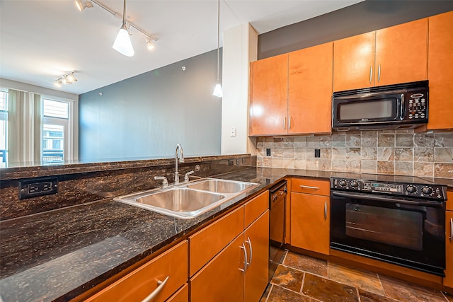 kitchen featuring tasteful backsplash, black appliances, sink, and pendant lighting