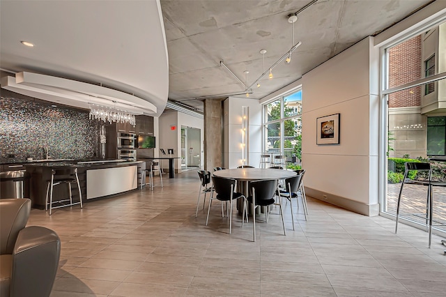 tiled dining room featuring sink