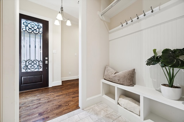 mudroom with an inviting chandelier and hardwood / wood-style flooring