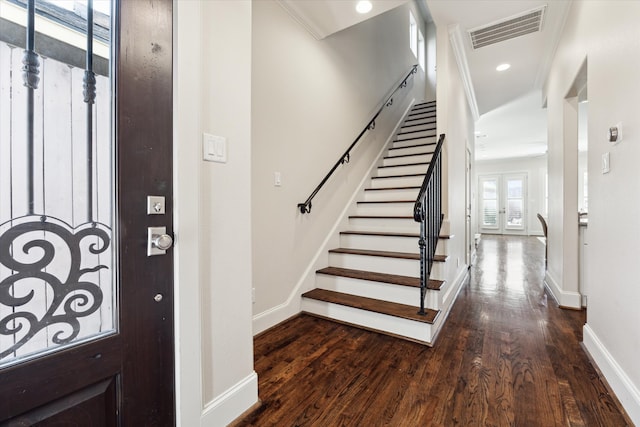 entryway with ornamental molding, french doors, and dark hardwood / wood-style flooring