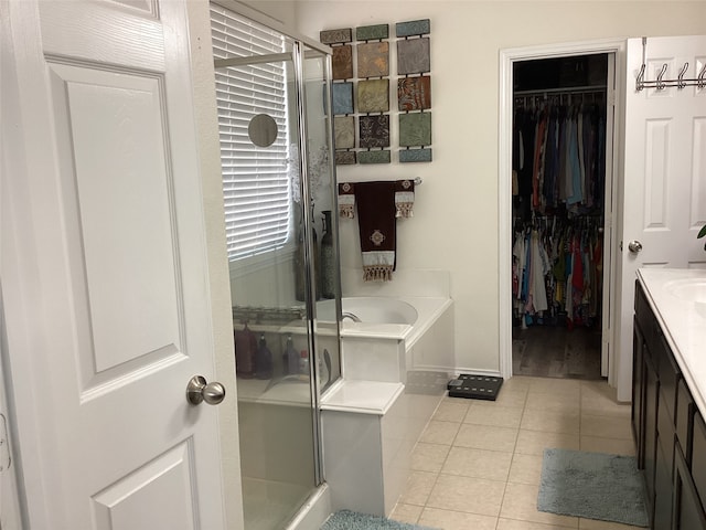 bathroom with vanity, plus walk in shower, and tile patterned flooring