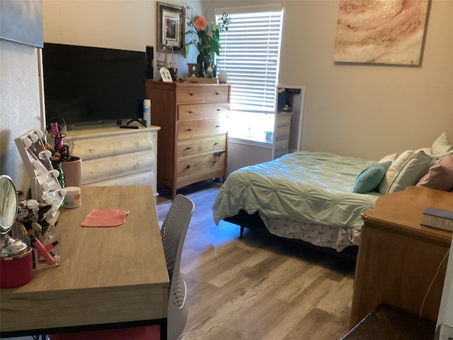 bedroom featuring multiple windows and hardwood / wood-style floors