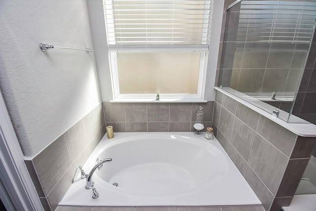 bathroom with tiled bath