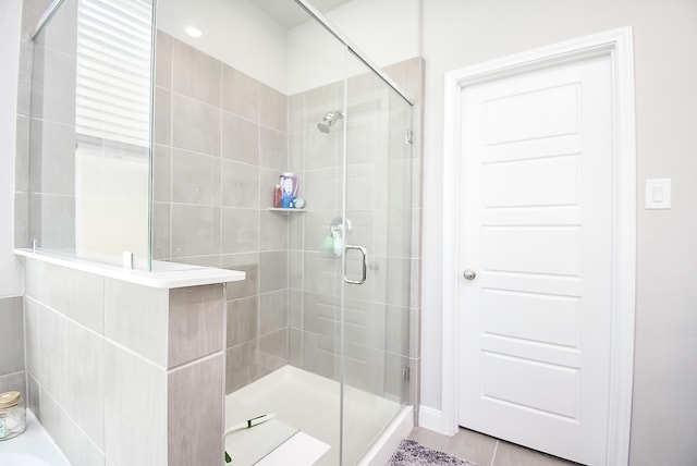 bathroom featuring tile patterned floors and an enclosed shower