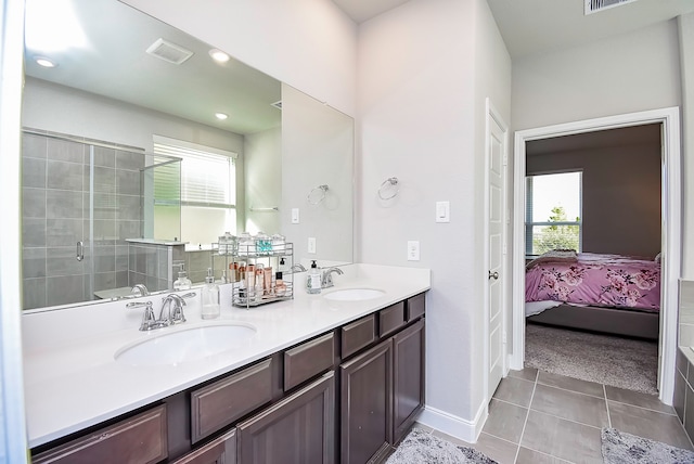 bathroom with vanity, tile patterned floors, and a shower with door