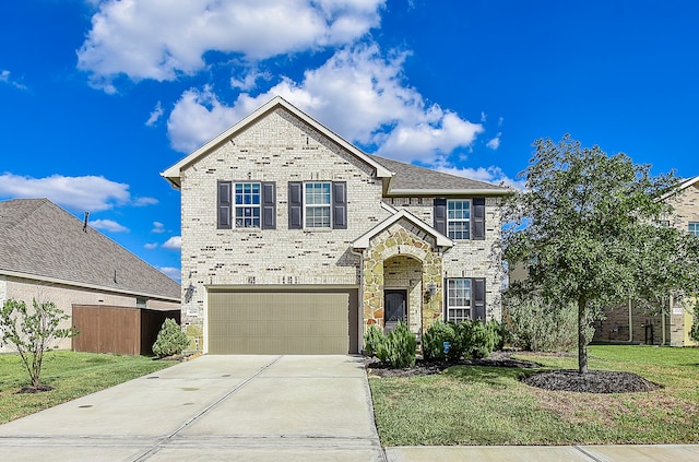 front facade featuring a front yard and a garage