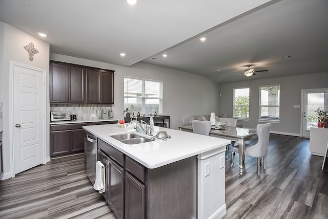 kitchen featuring dark hardwood / wood-style floors, sink, a wealth of natural light, and a center island with sink