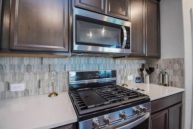 kitchen with appliances with stainless steel finishes, dark brown cabinetry, and tasteful backsplash