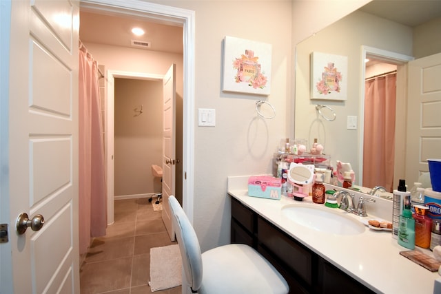 bathroom with vanity, toilet, and tile patterned flooring