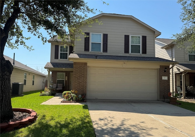 view of front of property featuring a garage, a front yard, and central AC