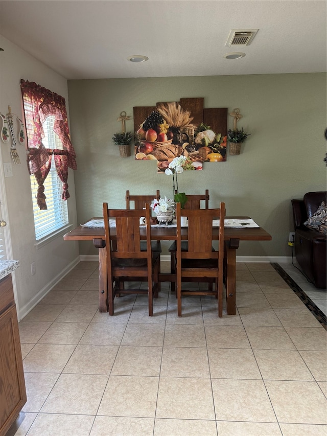 dining area with light tile patterned floors