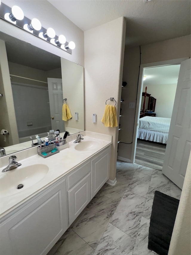 bathroom featuring vanity, a shower with shower curtain, and a textured ceiling