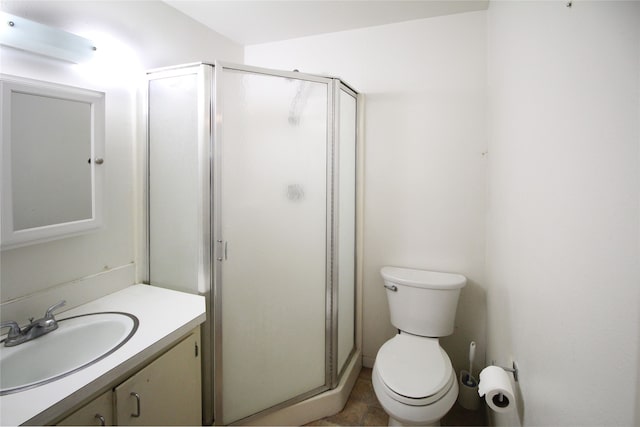 bathroom with vanity, tile patterned flooring, toilet, and a shower with door