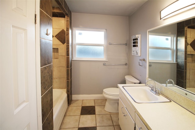 full bathroom featuring vanity, tile patterned flooring, toilet, and tiled shower / bath combo