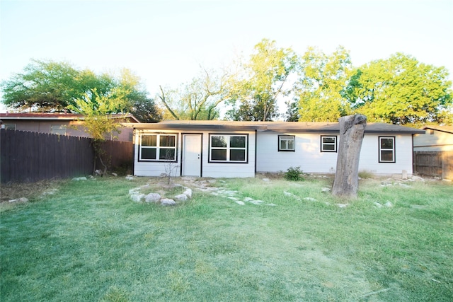 327 W Mulberry St, Fredericksburg, TX 78624 - back of house with a fenced backyard and a lawn