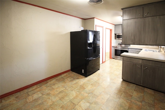 kitchen featuring ornamental molding, dark brown cabinetry, sink, and stainless steel appliances