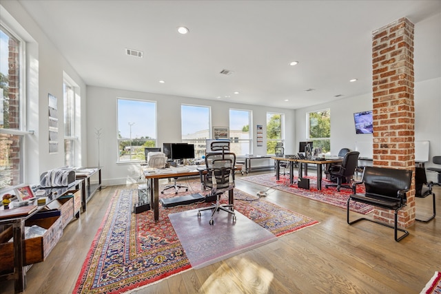 home office featuring ornate columns and light hardwood / wood-style floors