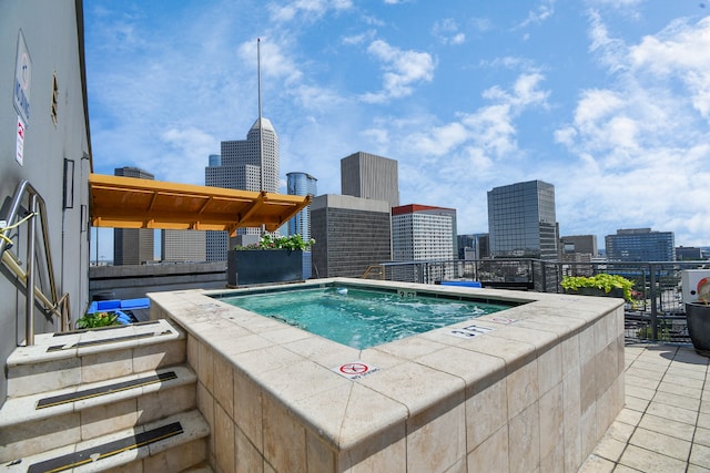 view of pool with an in ground hot tub